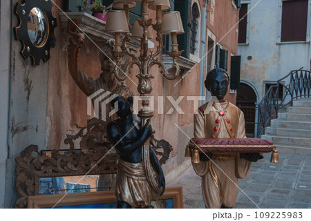 A statue of a black child serving in a luxury style in Venice, Italy. 109225983