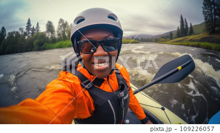 Joyful African-American woman makes selfie rafting on wide calm river closeup 109226057