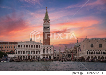 Aerial view of Venice, Italy, showcasing iconic architecture and waterways. The city's unique layout and charm are captured, with boats dotting the water and colorful, intricate buildings. 109226481