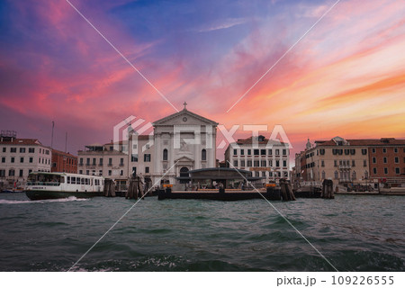 Unique perspective of Venice from the water, capturing the city's landmarks on a cloudy day. Scenic view with no visible boats, providing a gloomy atmosphere. 109226555