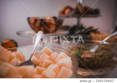 A delicious buffet spread with a variety of food items including melon, cheese, and crackers. The specific types of cheese and crackers are unknown. A delicious buffet spread with a variety of food items including melon, cheese, and crackers. The specific types of cheese and crackers are unknown. 109226607