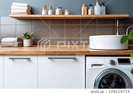 Laundry room interior with modern washing machine and stylish vessel sink on wooden Laundry room interior with modern washing machine and stylish vessel sink on wooden 109229714