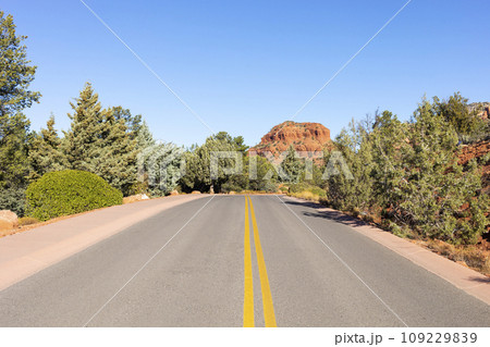 Long Straight Road Leading Towards Red Rock Mountain Butte Of Sedona, Arizona, USA Within Coconino National Forest. Beautiful Scenic Landscape. Attraction, Spiritual Place. Horizontal 109229839