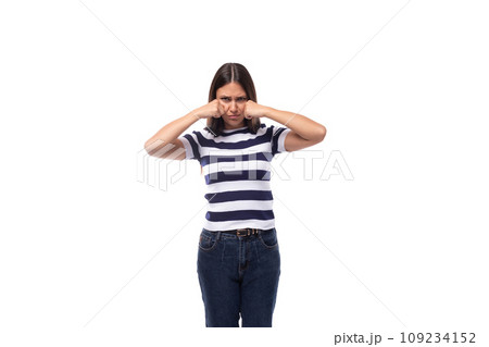 offended young brunette caucasian woman with light makeup dressed in a striped t-shirt and jeans offended young brunette caucasian woman with light makeup dressed in a striped t-shirt and jeans 109234152