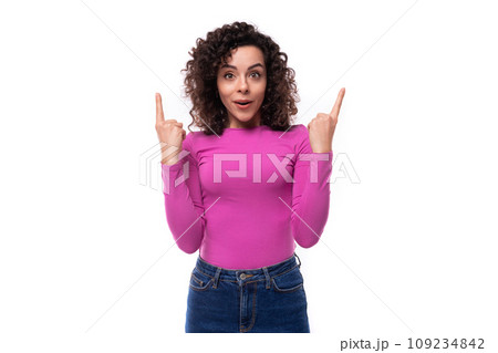 young curly promoter woman dressed in a lilac turtleneck gesturing with her hands young curly promoter woman dressed in a lilac turtleneck gesturing with her hands 109234842