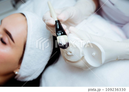 Facial rejuvenation procedure with cream. Spa and cosmetology skin care. Beauty mask Close-up 109236330