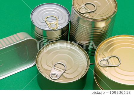 Unopened Tin Cans with Blank Edges on Green Background 109236518