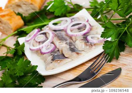 Salted herring fillet with onion Salted herring fillet with onion 109236548
