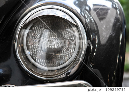 Classic round headlight of an old timer car, front view. Close up Classic round headlight of an old timer car, front view. Close up 109239755