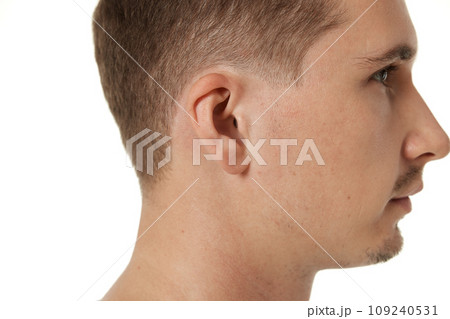 Close up of male ear on white studio background Close up of male ear on white studio background 109240531