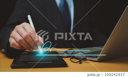 Businessman use electronic pen sign signature on electronic E-signing, data sheet document management, Electronic signature and paperless office concept. 109242837