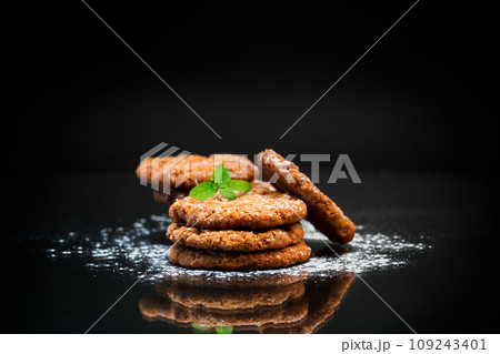 cooked sweet oatmeal cookies on black background cooked sweet oatmeal cookies on black background 109243401