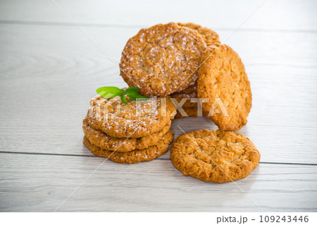 cooked sweet oatmeal cookies on wooden table 109243446