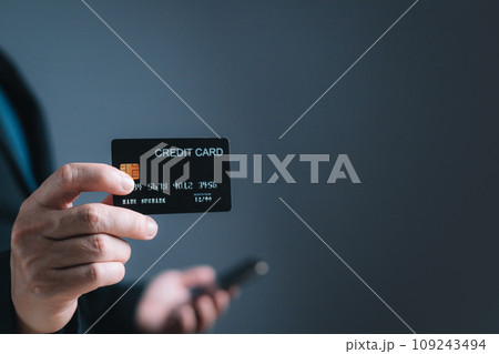 businessman hold credit card and use smartphone to buy or purchase produce payment online. The concept of finance and online shopping. 109243494