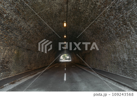 Infrastructure auto tunnel illuminated by lights at end Infrastructure auto tunnel illuminated by lights at end 109243568