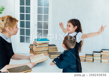 Teacher teaching children at school in lesson Teacher teaching children at school in lesson 109243656