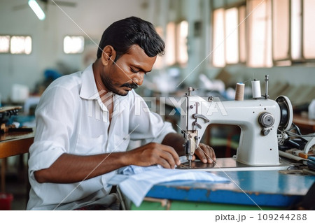 Focused elderly man tailor with experience sews things from natural fabric using sewing machine Focused elderly man tailor with experience sews things from natural fabric using sewing machine 109244288