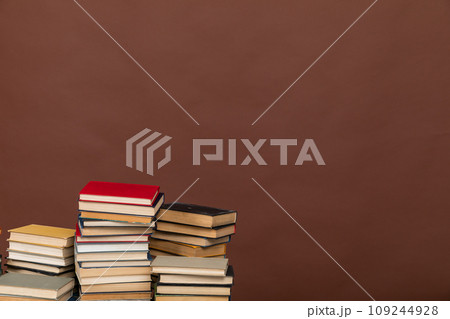 Many stacks of educational books to study in the university library on a background Many stacks of educational books to study in the university library on a background 109244928