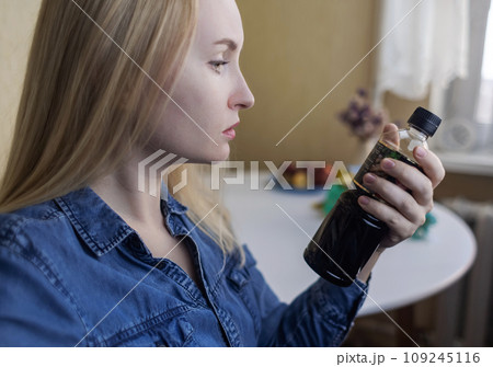 Woman reads instructions for food products at home. Checking labels on goods. Study of product compositions. Search Internet for descriptions of product gradients. Useful or harmful. Nutritionology Woman reads instructions for food products at home. Checking labels on goods. Study of product compositions. Search Internet for descriptions of product gradients. Useful or harmful. Nutritionology 109245116