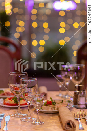 Served festive table with snacks, glasses, glasses, cutlery and napkins for a banquet 109246645