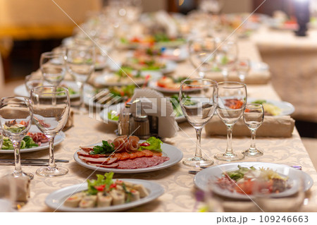 Served festive table with snacks, glasses, glasses, cutlery and napkins for a banquet 109246663