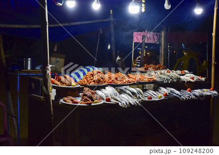Street food and cuisine made with different types of Ocean fishes, crabs, octopus etc. at  the sea beach side of Puri seashore , Odisha, India, Asia 12.02.2020. 109248200