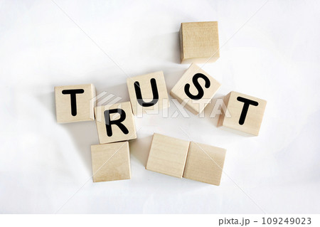 Trust is the word written on wooden blocks. White background. Business concept for your design 109249023