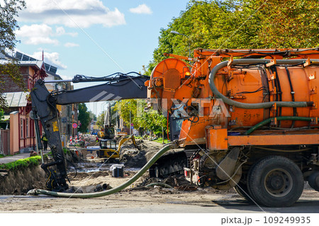 City street rebuilding view, combined vacuum suction and canal jetting machine in foreground City street rebuilding view, combined vacuum suction and canal jetting machine in foreground 109249935