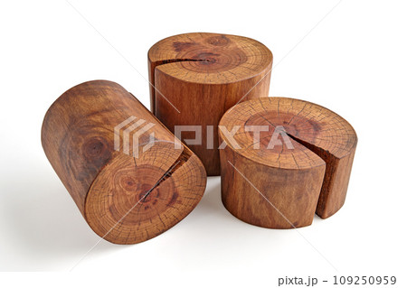 Wooden brown pedestal for advertising from three cuts of natural wood with a crack, isolated on a white background Wooden brown pedestal for advertising from three cuts of natural wood with a crack, isolated on a white background 109250959