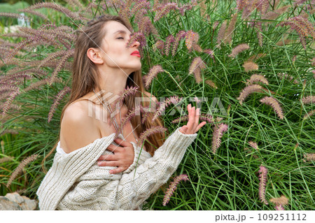 Beautiful caucasian woman near bush. 109251112
