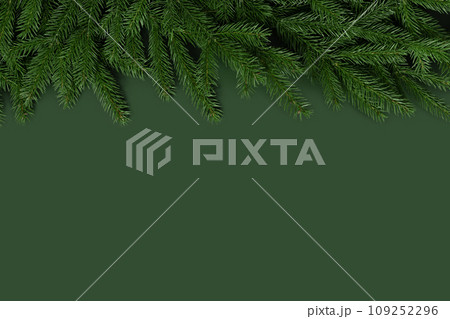 Christmas border with fir branches. Christmas green background with a copy space. New Year card. Top view, flat lay. 109252296
