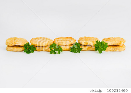 Breaded Chicken Inner Fillet on a White Background,Chicken Breaded Raw Meat.Chicken Breaded Fillet. Breaded chicken nuggets. Fast homemade food at home. Chicken breaded schnitzels. Fast cooking. 109252460