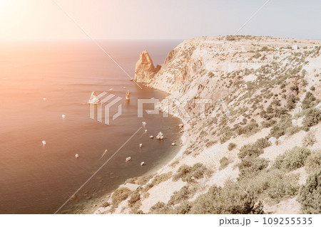 Aerial view from above on calm azure sea and volcanic rocky shores. Small waves on water surface in motion blur. Nature summer ocean sea beach background. Nobody. Holiday, vacation and travel concept 109255535