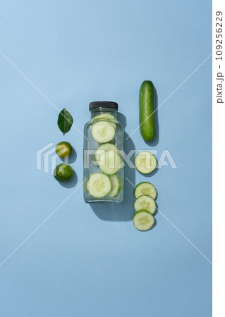 A glass bottle without label is decorated with kumquats and few slices of cucumber. Cucumber has anti-inflammatory properties that can reduce skin inflammation effectively. 109256229