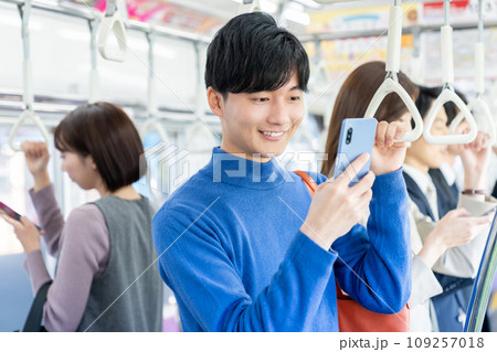 電車でスマホを見る若い大学生 撮影協力「京王電鉄株式会社」 電車でスマホを見る若い大学生 撮影協力「京王電鉄株式会社」 109257018