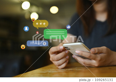 Young woman using social media, commenting and sharing posts commenting on mobile phone 109265131