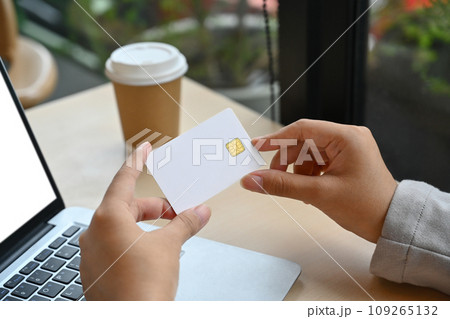 Close up female hands holding credit card and using laptop doing secure payment or shopping Close up female hands holding credit card and using laptop doing secure payment or shopping 109265132