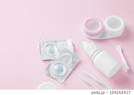 Contact lenses with container, eye drop and accessories on pink background, copy space 109268417