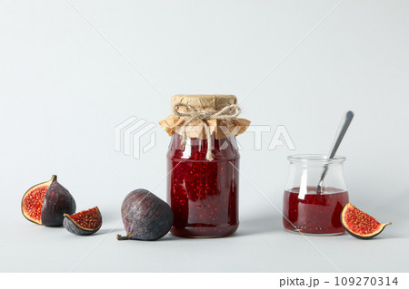Figs and jars of jam on white background Figs and jars of jam on white background 109270314