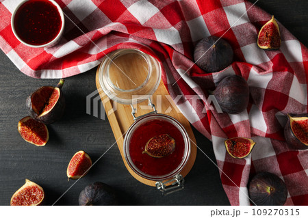 Figs, jars of jam and towel on gray background, top view Figs, jars of jam and towel on gray background, top view 109270315