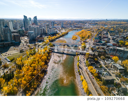 Prince's Island Park Peace Bridge autumn foliage scenery. Aerial view of Downtown City of Calgary. Alberta, Canada. 109270668