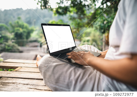 Working on a laptop on the balcony of a country house 109272977