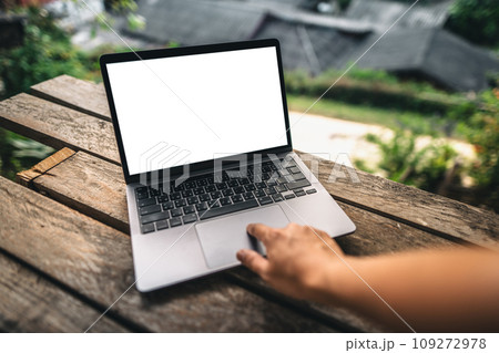 Working on a laptop on the balcony of a country house 109272978
