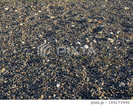Rock on the sand. Rubble on the ground. Stones scattered on the ground. Rock on the sand. Rubble on the ground. Stones scattered on the ground. 109273490