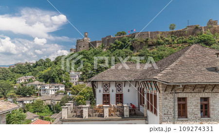 Panorama showing Gjirokastra city from the viewpoint with the fortress of the Ottoman castle of Gjirokaster timelapse. 109274331