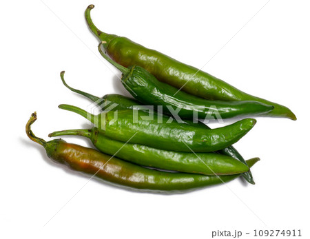 Fresh green chili peppers. Spicy vegetable isolate. Peppers on a white background. Ingredient for dishes. The concept of spicy food. Fresh chili pepper. Harvesting vegetables for seasonings. 109274911