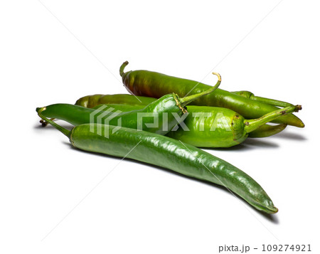 Fresh green chili peppers. Spicy vegetable isolate. Peppers on a white background. Ingredient for dishes. The concept of spicy food. Fresh . Harvesting vegetables for seasonings. Fresh green chili peppers. Spicy vegetable isolate. Peppers on a white background. Ingredient for dishes. The concept of spicy food. Fresh . Harvesting vegetables for seasonings. 109274921
