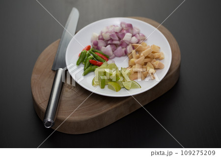Herbs and sliced vegetables for cooking 109275209