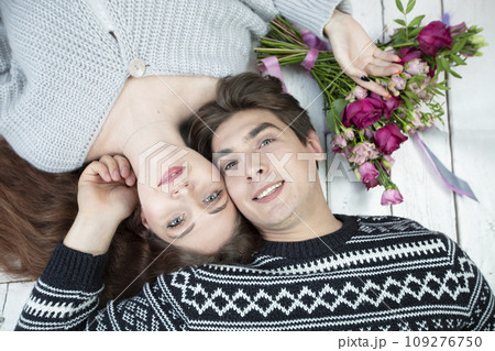 The face of a man and woman from above. Lovers with flowers. A beautiful couple. Love concept 109276750