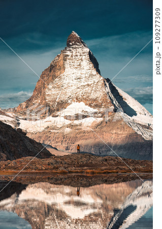 Matterhorn mountain with tourist standing reflecs in Riffelsee lake at Switzerland Matterhorn mountain with tourist standing reflecs in Riffelsee lake at Switzerland 109277309